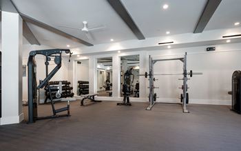 A spacious gym with a variety of equipment.